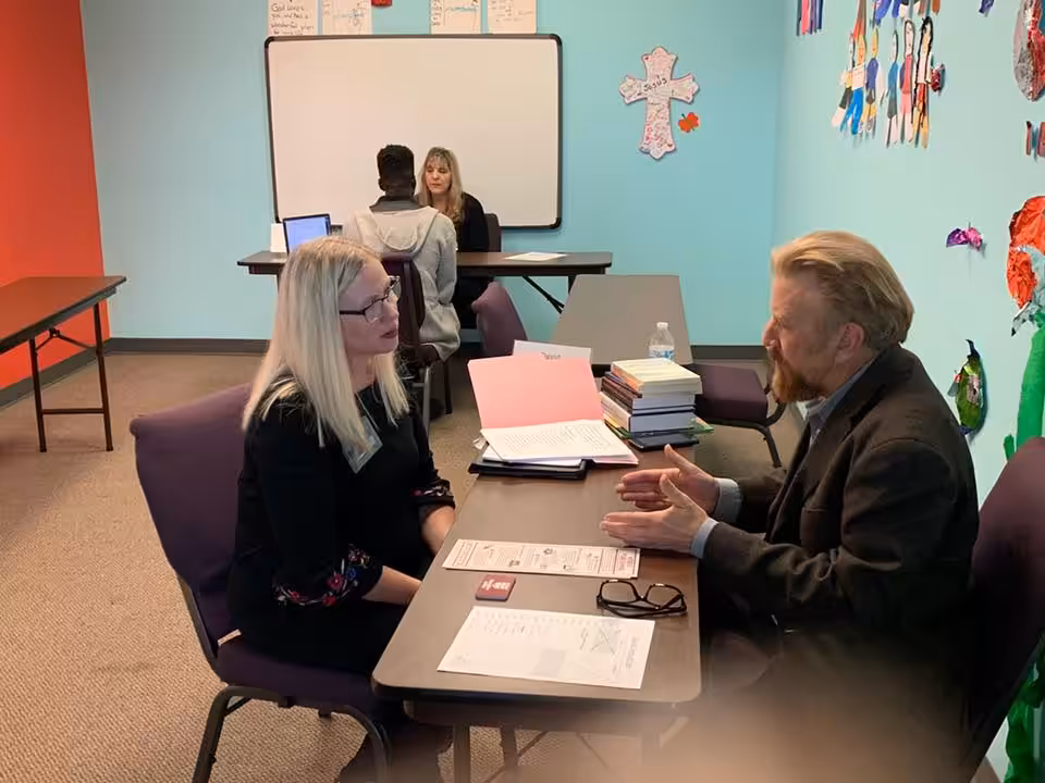 Photo of David Braughler, President and CEO of Braughler Books, working one-on-one with an attendee at the Ohio Christian Writers Conference